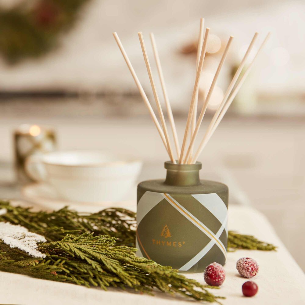 Thymes Frasier Fir Frosted Plaid Petite Reed Diffuser in use on table image number 1